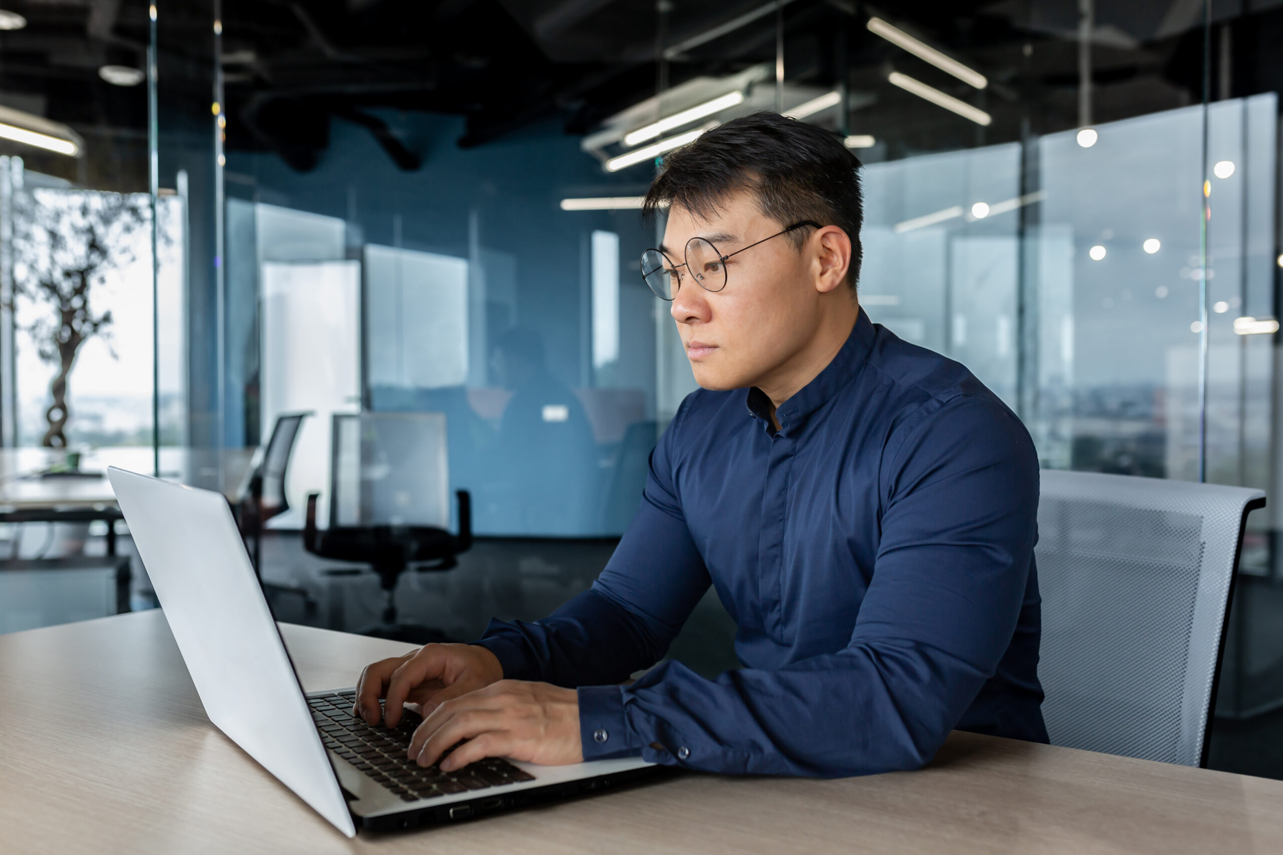 serious and focused businessman working with lapto for AI Tools in Your Business Contracts: What Every Atlanta Company Needs to Address Before Problems Arise