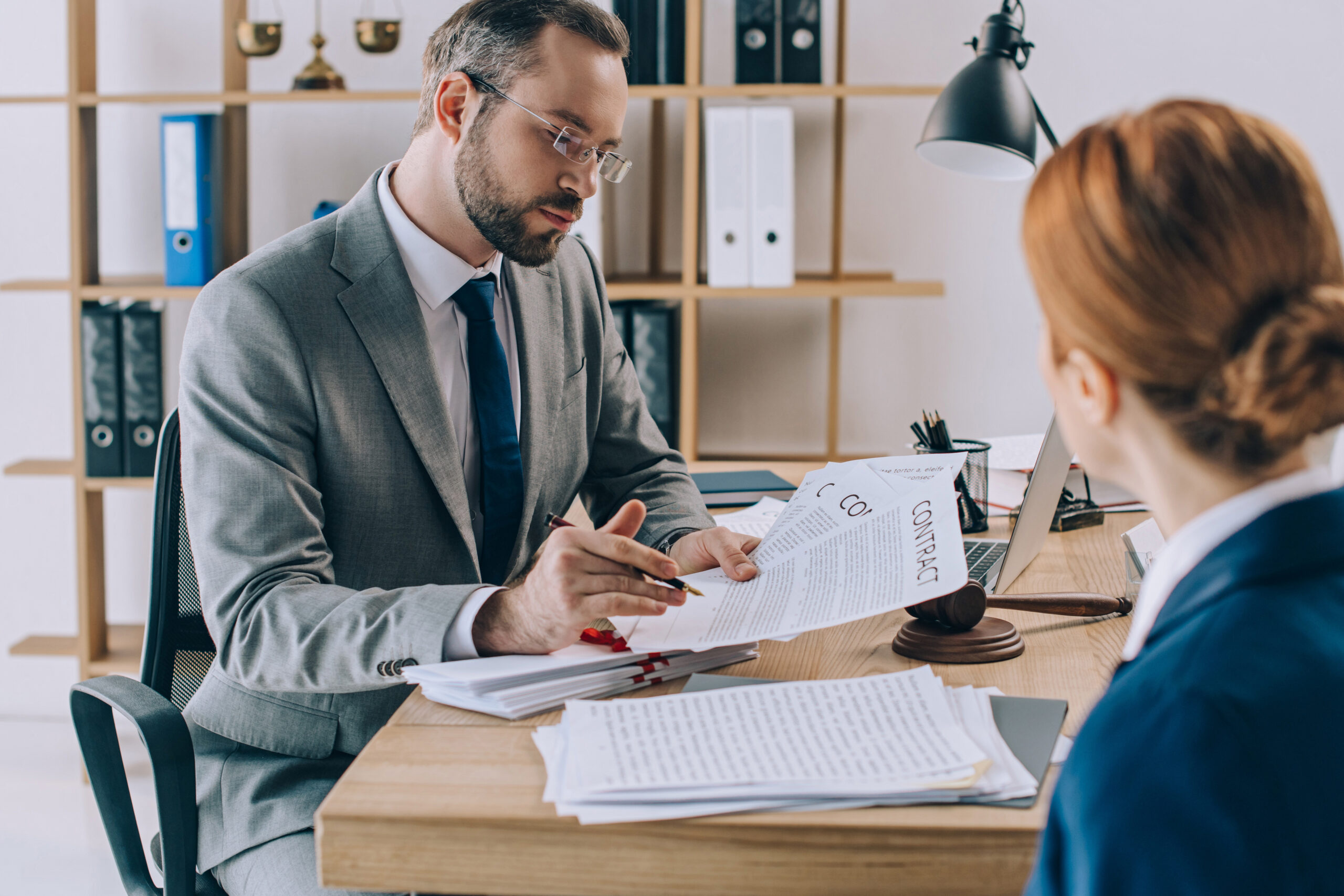 partial view of business owener discussing contract for AI Tools in Your Business Contracts: What Every Atlanta Company Needs to Address Before Problems Arise