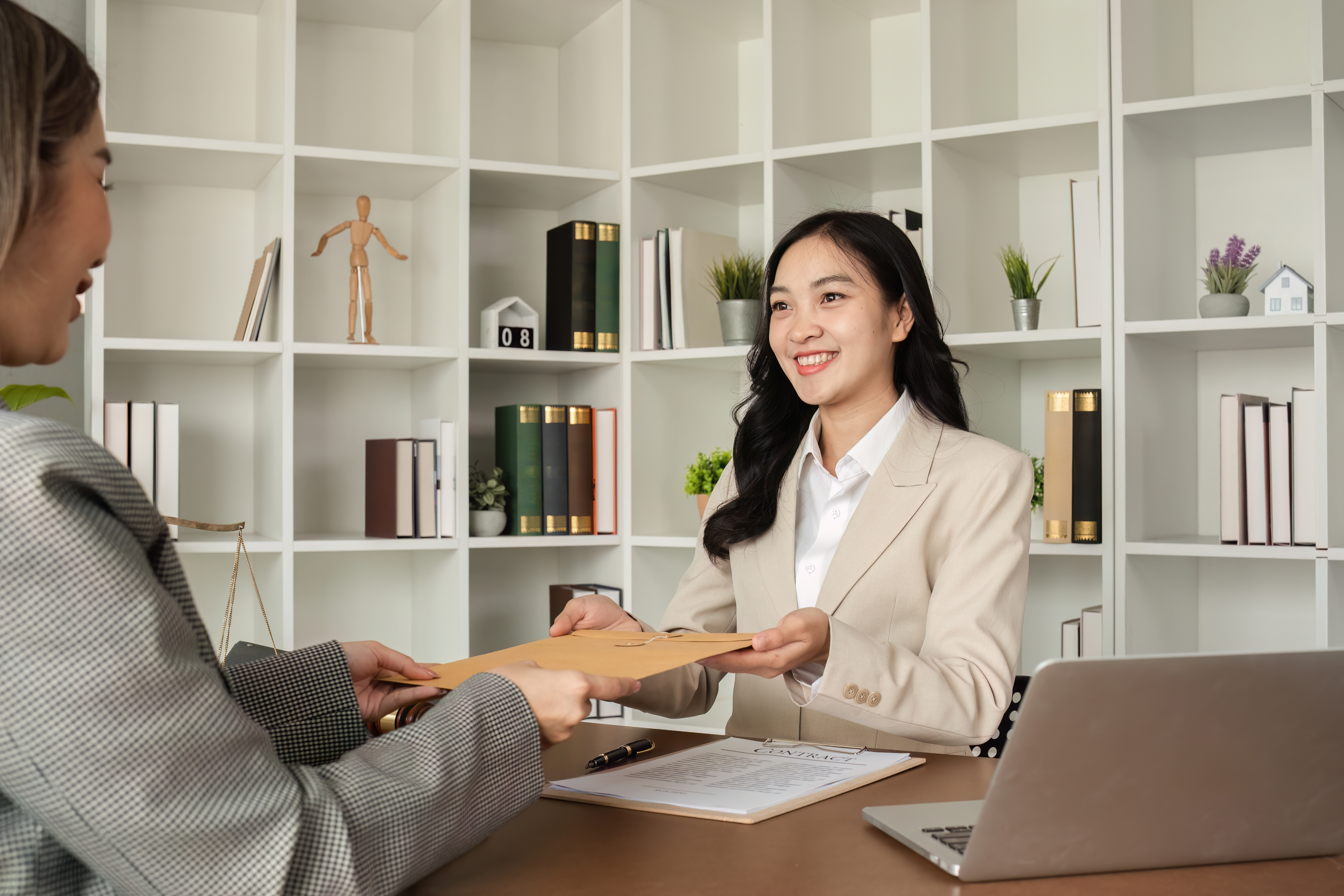 professional woman receives document in office set for Business Succession Planning for Georgia Small Business Owners: The Legal Steps Most Owners Skip