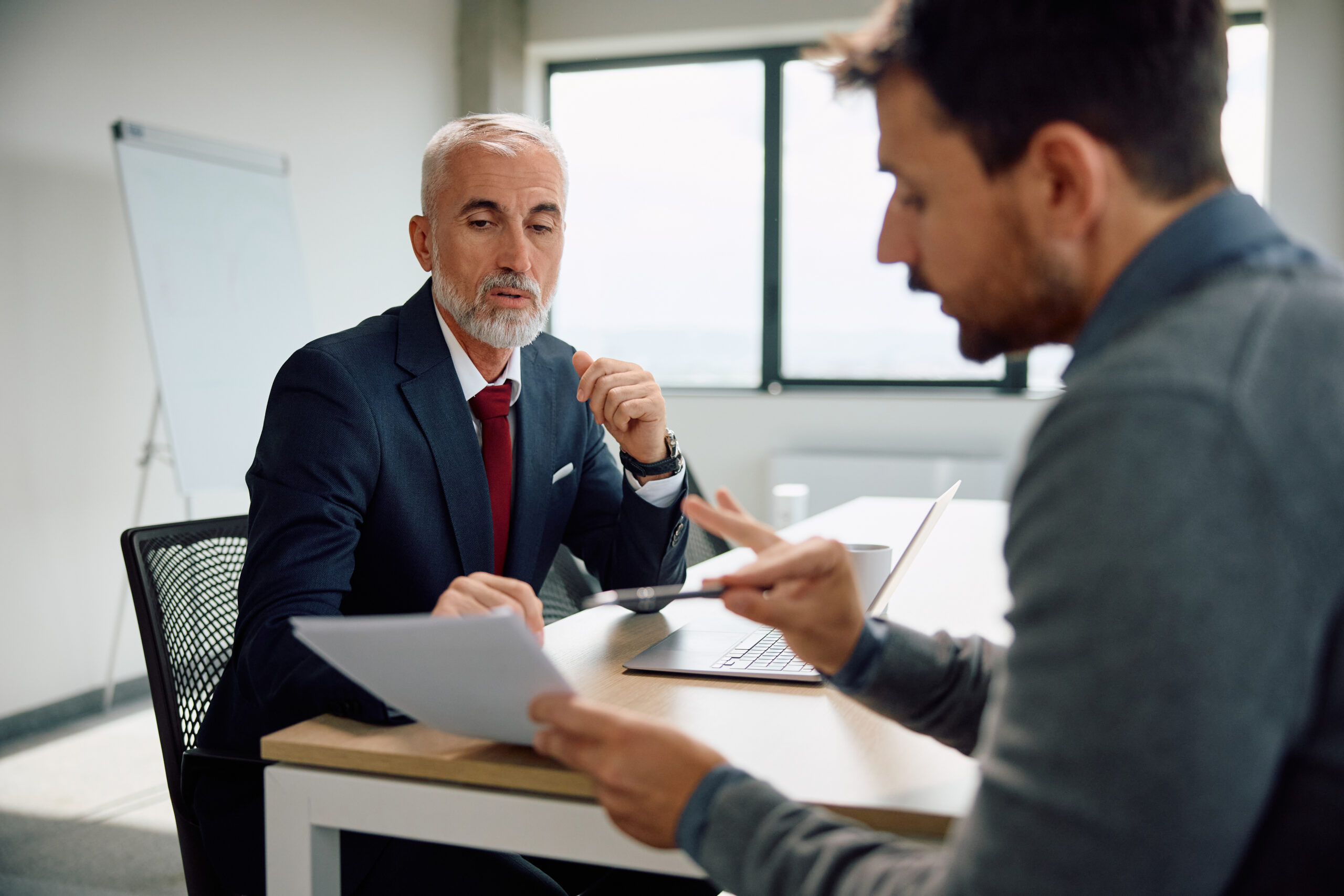 mature ceo and his colleague analyzing business re for Personal Guarantees in Georgia Business Contracts: When You Sign One, You're Putting Your Personal Assets on the Line