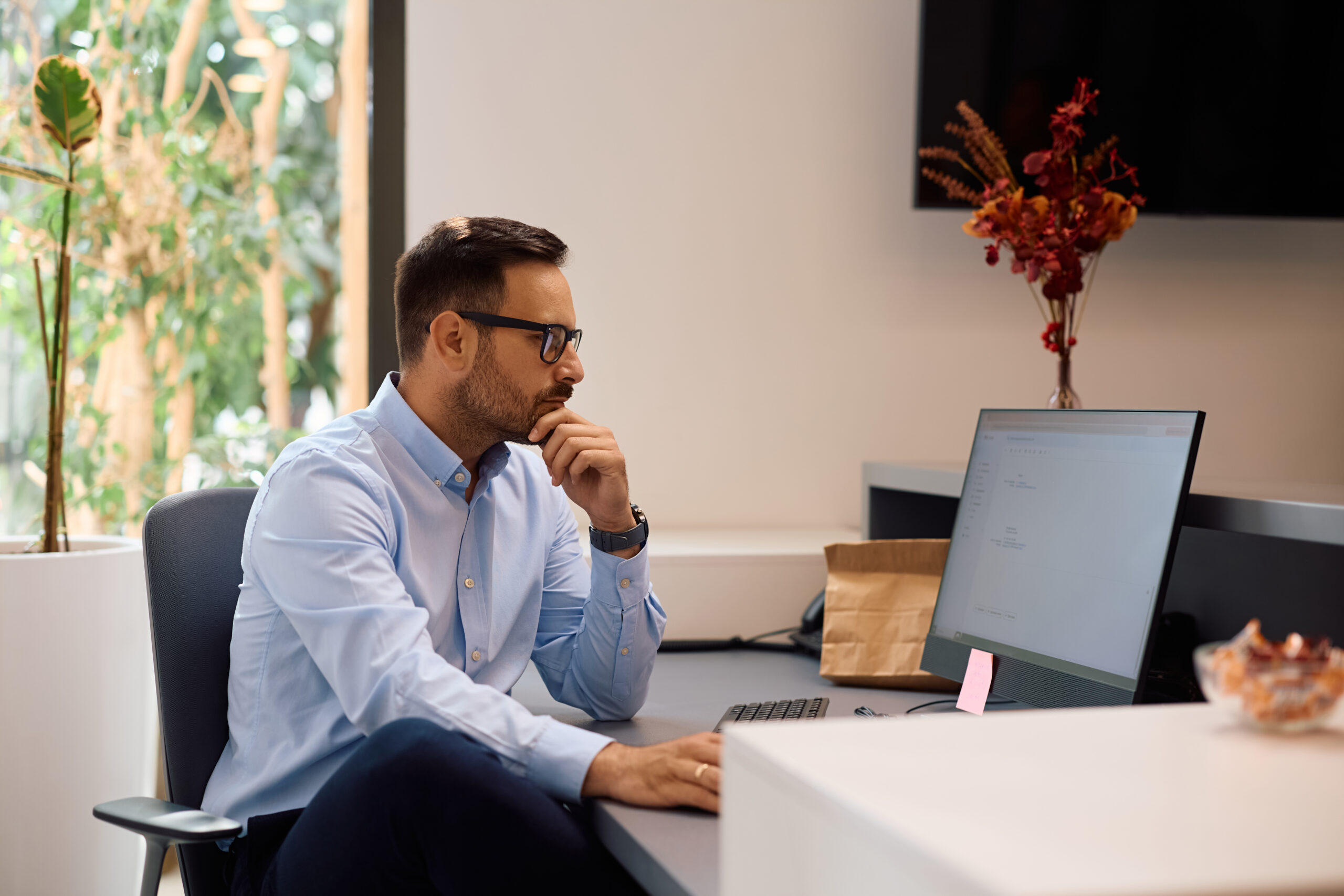 pensive businessman reading an e mail on a compute for Trade Secrets and Confidential Information in Georgia: What Your Business Actually Needs to Protect Itself