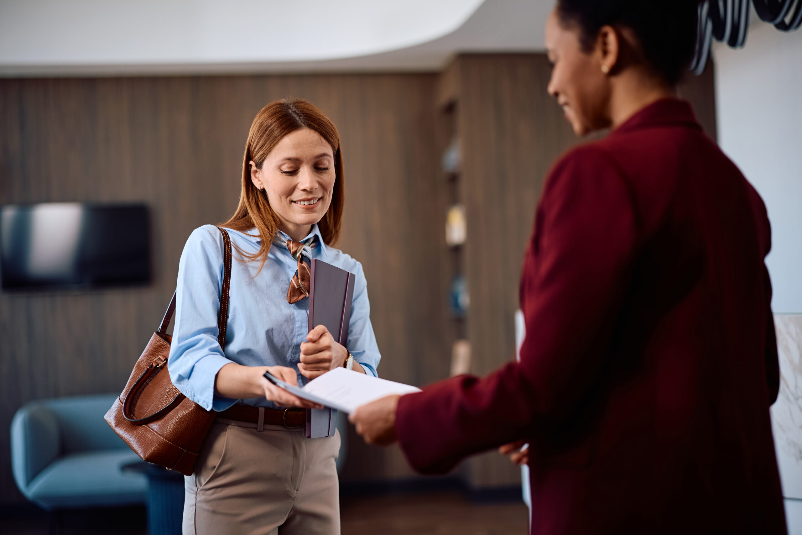 professional woman handing over documents in a mod for Trade Secrets and Confidential Information in Georgia: What Your Business Actually Needs to Protect Itself